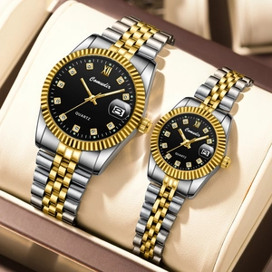 Close-up of gold-silver tone couple watches with diamond markers and calendar display