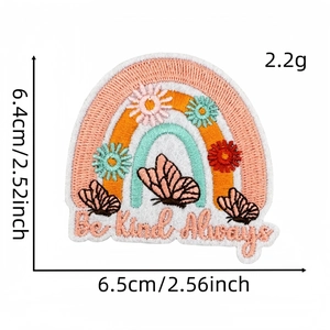 Detail of Be Kind Always embroidery patch featuring rainbow, butterfly and flower motifs