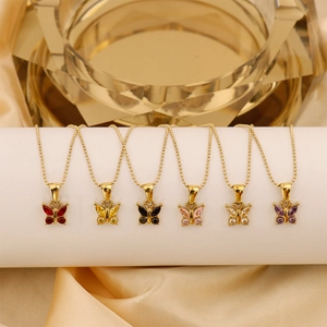 Detail of gold titanium necklaces with colorful zircon butterfly pendants on silk