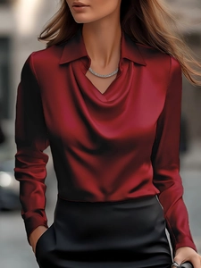 Detail of elegant wine red satin long sleeve shirt with draped neckline for women
