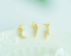 Macro shot of 18K gold plated celestial pendants with micro-paved cubic zirconia