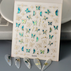 3D butterfly nail stickers with gold outlines and teal gradient on professional display