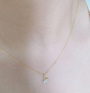 Close-up of gold S925 sterling silver necklace with three marquise cut crystals on neck