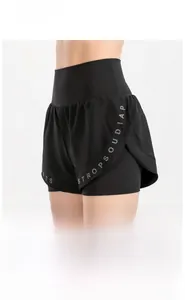 Detail of high-waisted black athletic shorts with double-layered design and letter prints