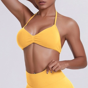 Macro detail of seamless yellow racerback sports bra with ribbed stretch fabric