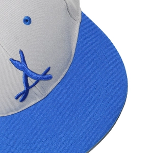 Detailed macro shot of 3D embroidered letter A on a grey and blue baseball cap