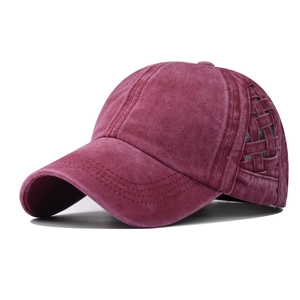 Detailed side view of washed burgundy ponytail baseball cap with criss-cross cutout design