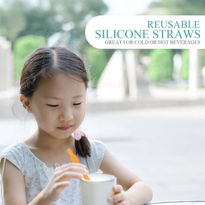 Reusable orange silicone straw for hot or cold drinks shown in outdoor use scenario