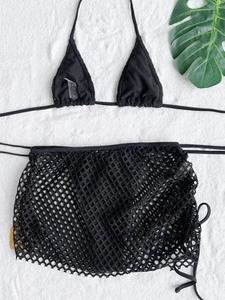 Flat lay of black three-piece bikini set with mesh skirt and drawstring detail