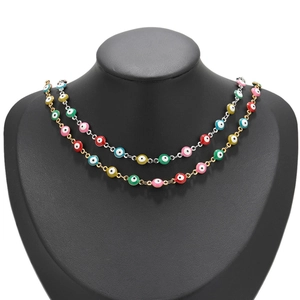 Detail of colorful Evil Eye charm chains in gold and silver plating on a black neck model