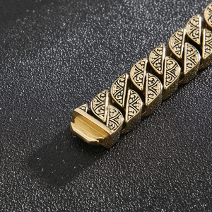 Macro detail of vintage totem engraving on golden titanium steel chain links