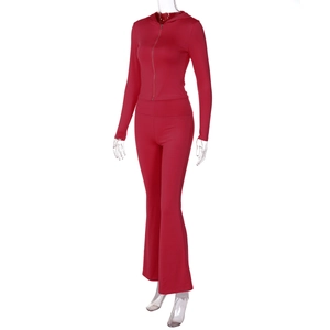 Detail view of red zip-up hoodie and flared pants set on transparent mannequin