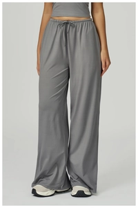 Close-up of gray wide-leg joggers featuring a drawstring elastic waist and soft texture