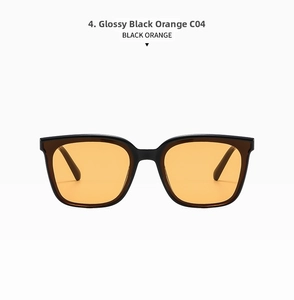 Detail view of large square sunglasses in bright black frames and orange lenses (C04)