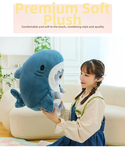 Detailed close-up of a large blue shark cat plush toy being hugged in a cozy home setting
