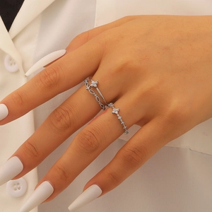 Macro view of silver floral multi-layer rings with zircons on elegant hand