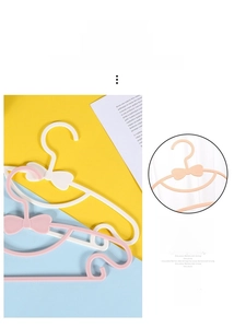 Detailed view of plastic bow-knot baby hangers with non-slip finish and durable PP material