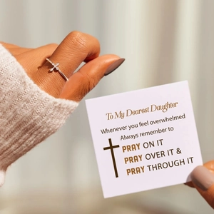 Detail of silver cross ring with zircons and inspirational gift card for daughter