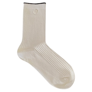 Ribbed cream crew socks with black trim and side button detail on white background