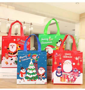 Detail of assorted Christmas non-woven gift bags with festive Santa and snowman prints