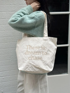 Detailed embroidery on white canvas tote bag with Korean style minimalist lettering