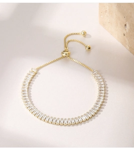 Detail of adjustable gold chain bracelet featuring square-cut sparkling zircon stones