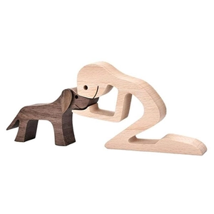Detailed close-up of a carved wooden figurine featuring a kneeling person with a dog