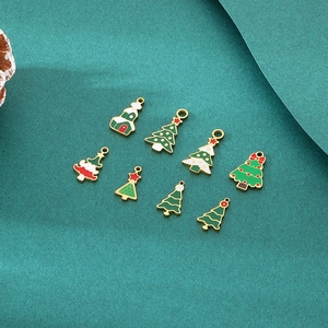 Close-up of eight colorful enamel Christmas tree pendants with gold-plated metal finish