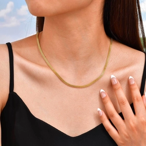Close-up of elegant gold mesh necklace on model's neck for a minimalist jewelry style