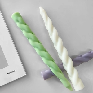 Three twisted spiral taper candles in green, white, and purple with matte finish