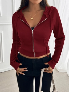 Detail of red ribbed texture and metal zipper on this slim fit hooded cardigan top
