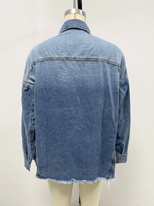 Detail view of the washed denim jacket back featuring horizontal seam and frayed hemline