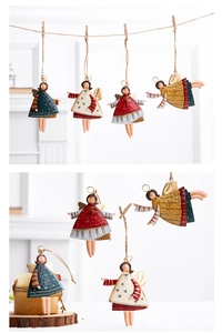 Close-up of vintage metal Christmas angel ornaments with colorful painted details