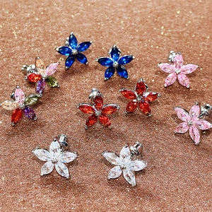 Macro shot of colorful marquise-cut zircon flower earrings with sparkling centers