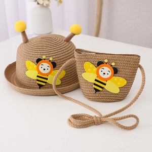 Cute children's straw hat and bee bag set with yellow pom-poms for summer sun protection