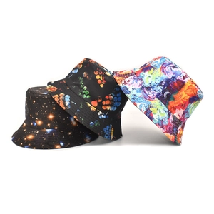 Detailed view of three stylish summer bucket hats with vibrant galaxy and abstract prints