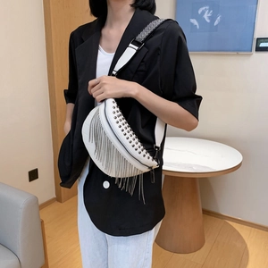 Fashionable white crossbody bag with black rivets, silver tassels and striped strap