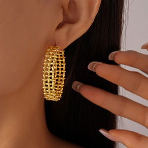 Close-up of 18K gold-plated C-shape hoop earring with unique woven texture on model