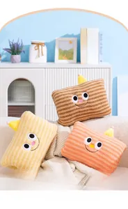 Plush hand warmers in brown, yellow and orange with embroidered cute cartoon faces