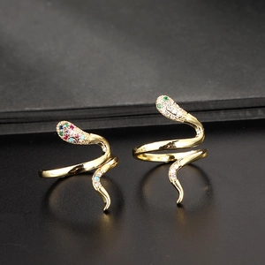 Detailed close-up of golden snake rings featuring sparkling zircon and rhinestone crystals
