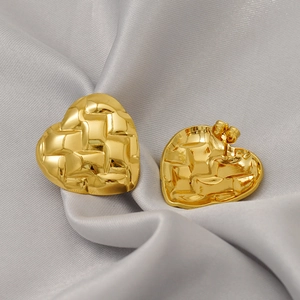 French vintage style heart earrings with quilted texture on elegant silk background