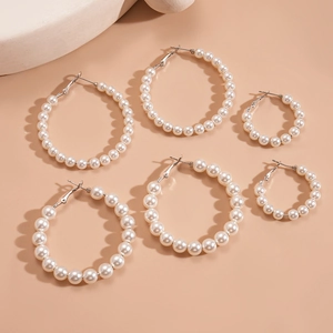 Three pairs of elegant faux pearl hoop earrings in silver plating for a minimalist style