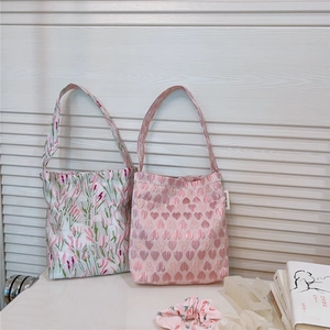 Detail of pink floral and heart embroidered fabric tote bags with matching scrunchies