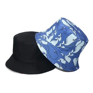 Classic cotton bucket hat in black and light blue with playful whale print