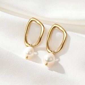 Elegant gold stainless steel irregular hoop earrings with white pearl pendants