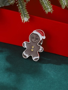 Broche bonhomme de pain d'épices de Noël en émail marron avec bonnet de fête rouge