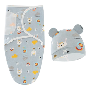Detailed flat lay of blue baby swaddle and matching hat set with cartoon rabbit patterns