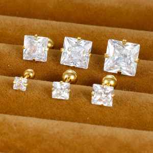 Close-up of square cut zircon stud earrings in various sizes with golden screw-backs