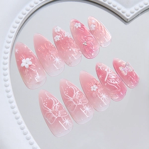 Pink cat eye almond press-on nails with 3D white butterfly and floral embossed details