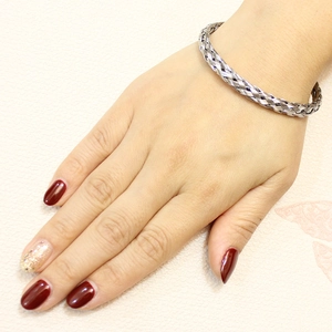 Detail showing high-quality silver braided mesh stainless steel bracelet on female wrist